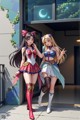 A couple of anime girls standing next to each other.