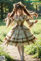 A woman in a dress is walking down a path.