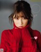 A woman in a red sweater on the cover of a magazine.