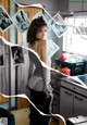 A woman standing in a kitchen next to a sink.